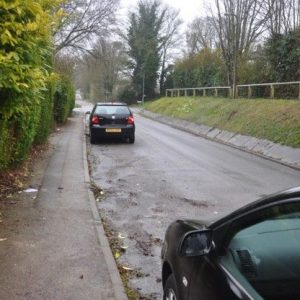 Water flowing down road outside 8 Briary Lane